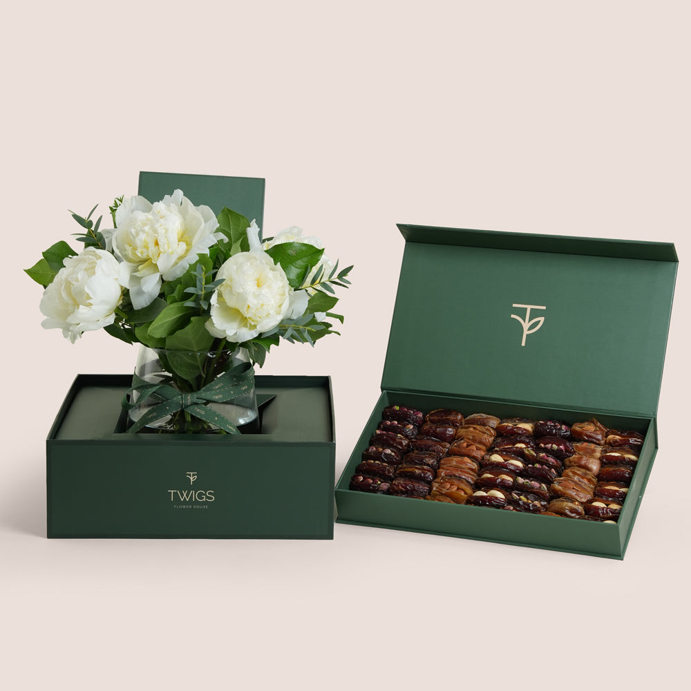 White peonies in a glass vase paired with a premium assorted stuffed dates and nuts gift box by TWIGS Flower House